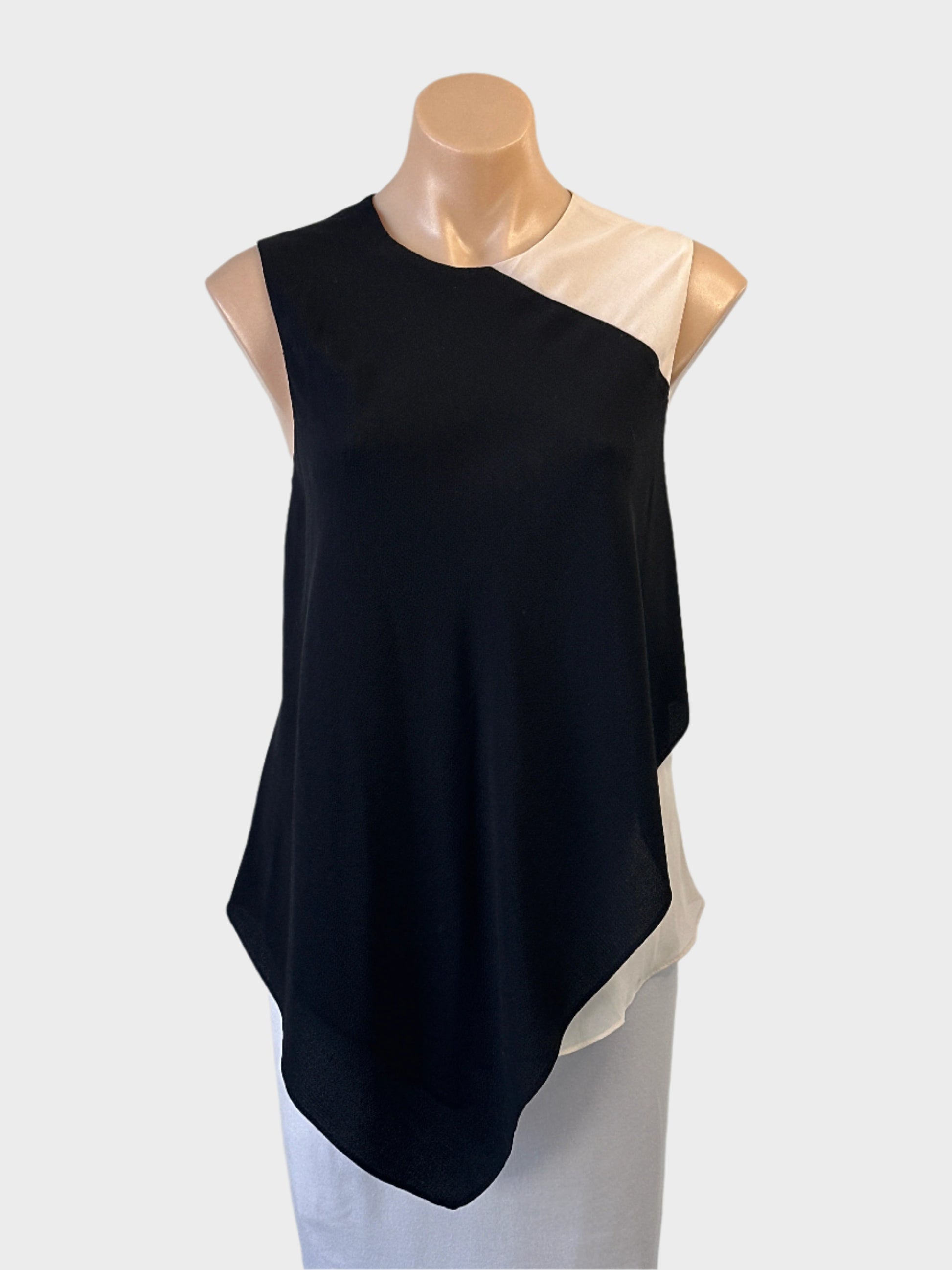 Designer Rachel Roy asymmetric top in black and white with sheer underlay and handkerchief hem for office or smart casual wear.