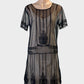 Retro 20's style black drop waist shift dress in sheer mesh with embroidered floral motifs for evening or special events.