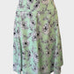 Review A-line panel skirt in green floral print crepe with yoke waist and belt loops for office wear.