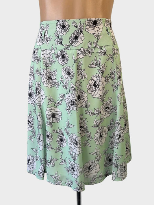 Review A-line panel skirt in green floral print crepe with yoke waist and belt loops for office wear.