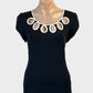 Review sleeveless top in black and white jersey with decorative eyelets for evening or office wear.