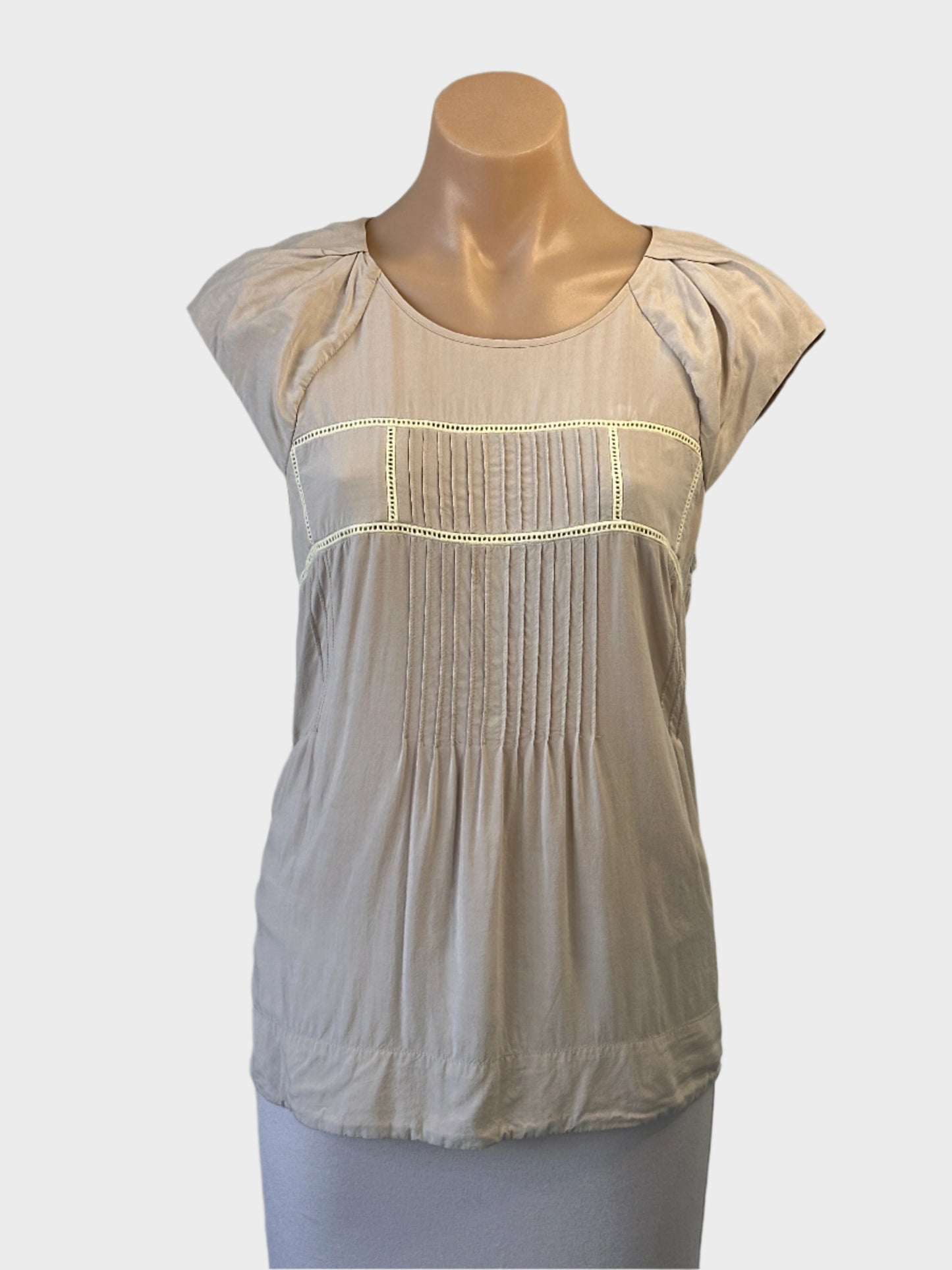 Rodeo Show top in beige with eyelet trim, pintuck panels and pleated cap sleeves for smart casual or office wear.