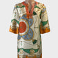 Designer Sarissa silk tunic top in orange and green with sequin detail and split hem for resort or special events wear.