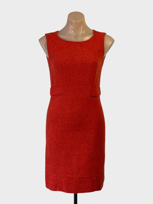 Vintage 60’s Sears sleeveless shift dress in orange wool with side tab waistband and scoop neck for smart casual or business wear.