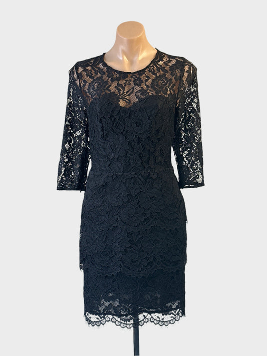 Seed lace sheath dress in black with illusion neck and peplum waist for evening wear.