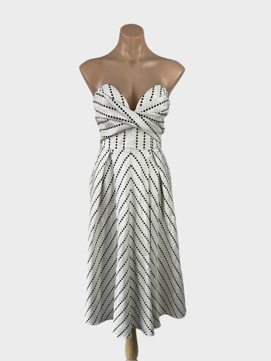 SHEIKE black and white strapless dress with chevron stripes, sweetheart neck, and pleated A-line skirt for special events or evening wear.