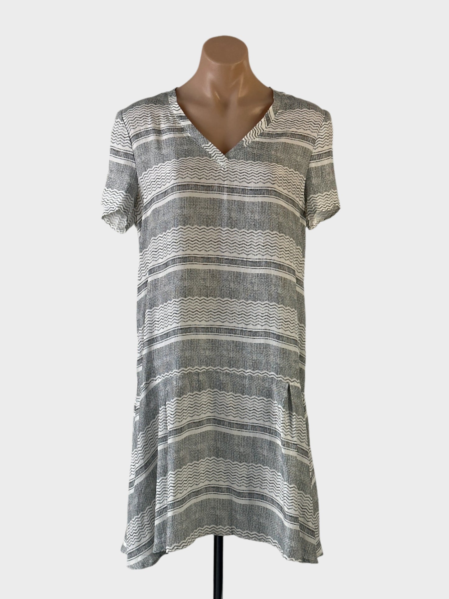 Designer SKIN & THREADS drop waist dress in grey pure silk with contrasting striped prints, v-neck and pleated skirt for smart casual and resort wear.