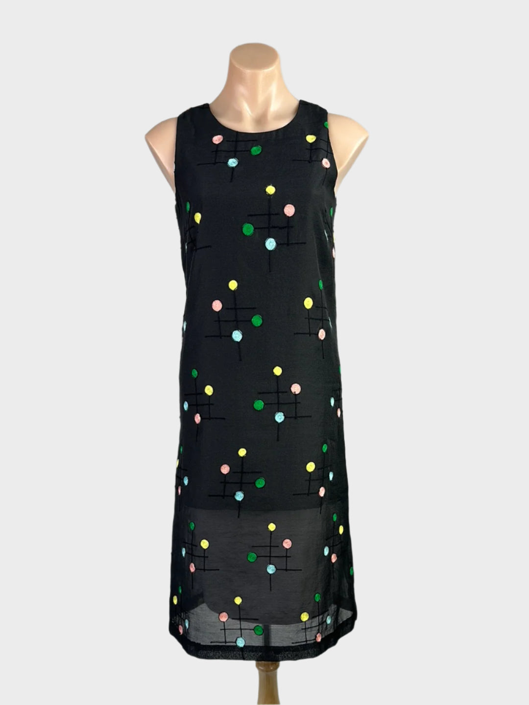 Retro 80's style sleeveless shift dress in sheer crepe with embroidered polka dots, bateau neck, and straight skirt.