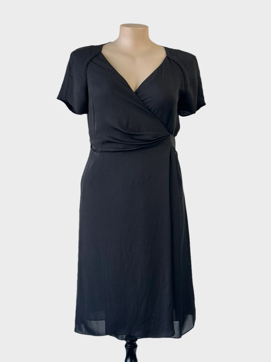 Sportscraft black silk A-line dress with surplice neck, wrap front panel, raglan sleeves and layered skirt for evening wear.