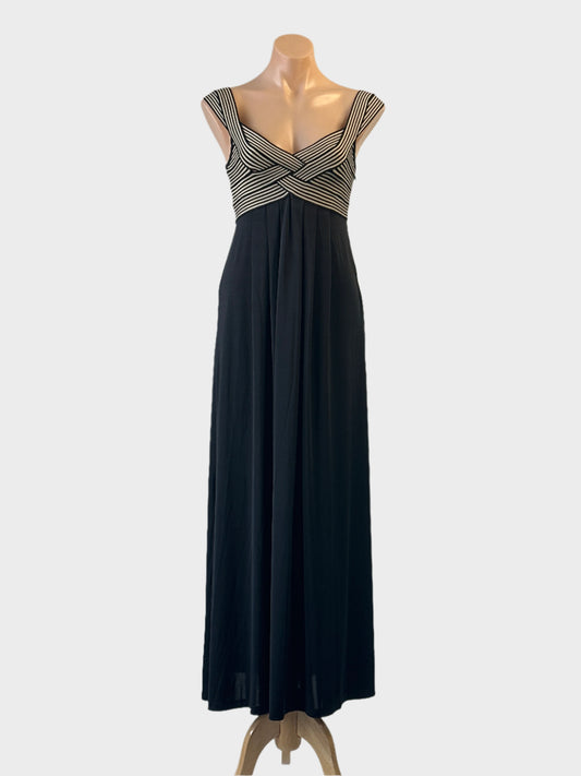 Striking jersey empire waist gown in black with pleated skirt and scoop back for evening wear.