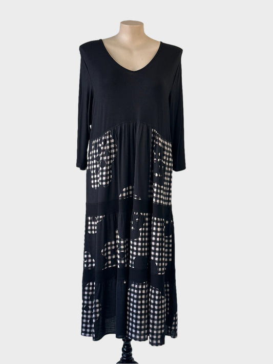 Taking Shape dress in black & white with v-neck, three quarter sleeves and contrasting gingham tiered skirt with inseam pockets for smart casual wear.