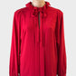 Designer Tara Jarmon top in red crepe with pleated front and bow tie neck for special events or office wear.