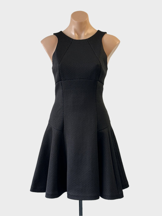 Designer Ted Baker drop waist dress in black polka dot scuba with racer back and skater skirt for evening wear.