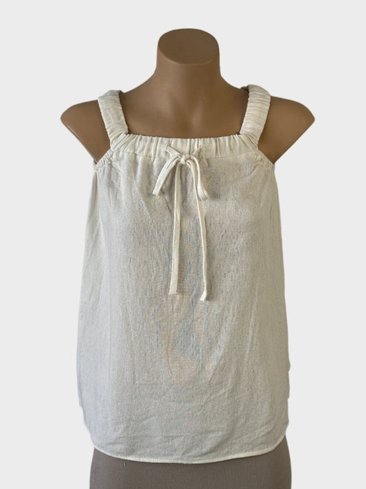 THE LABEL sleeveless top in white textured weave with garterised neckband, drawstring tie and shoulder straps for resort wear or smart casual.