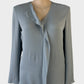 Designer Theory classic top in grey crepe with v-neck flounce, long sleeves and notched hem for office or special events.