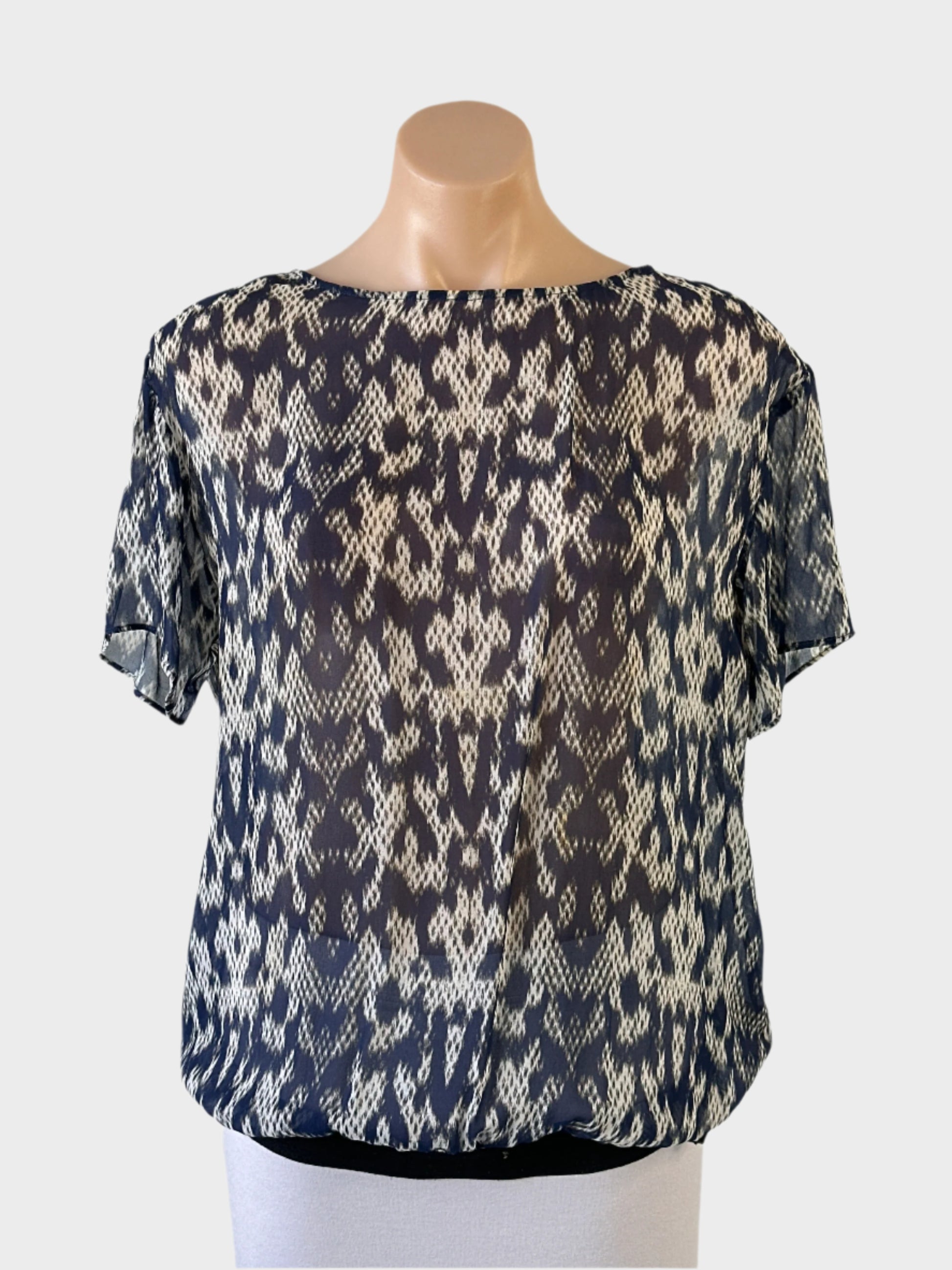 Trussardi blouson top in blue ikat print sheer crepe with tie back and elastic hip band for office or smart casual wear.