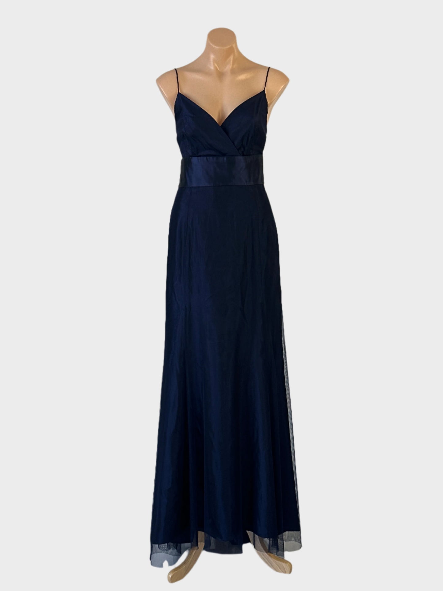 Designer Vera Wang empire waist gown in blue sheer net with surplice neck, open back and flared panel skirt for bridal or formal wear.