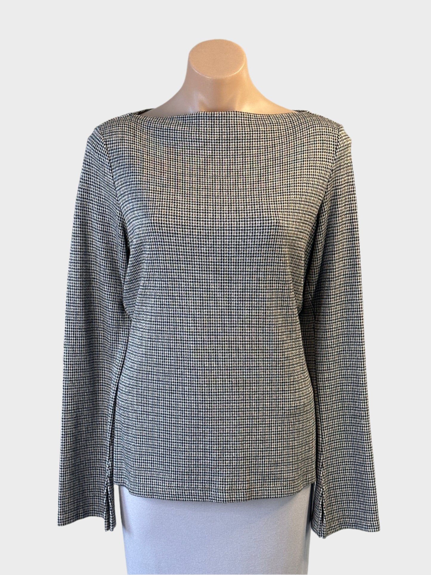 Veronika Maine jersey top in cream and black houndstooth with notched cuffs for office wear.