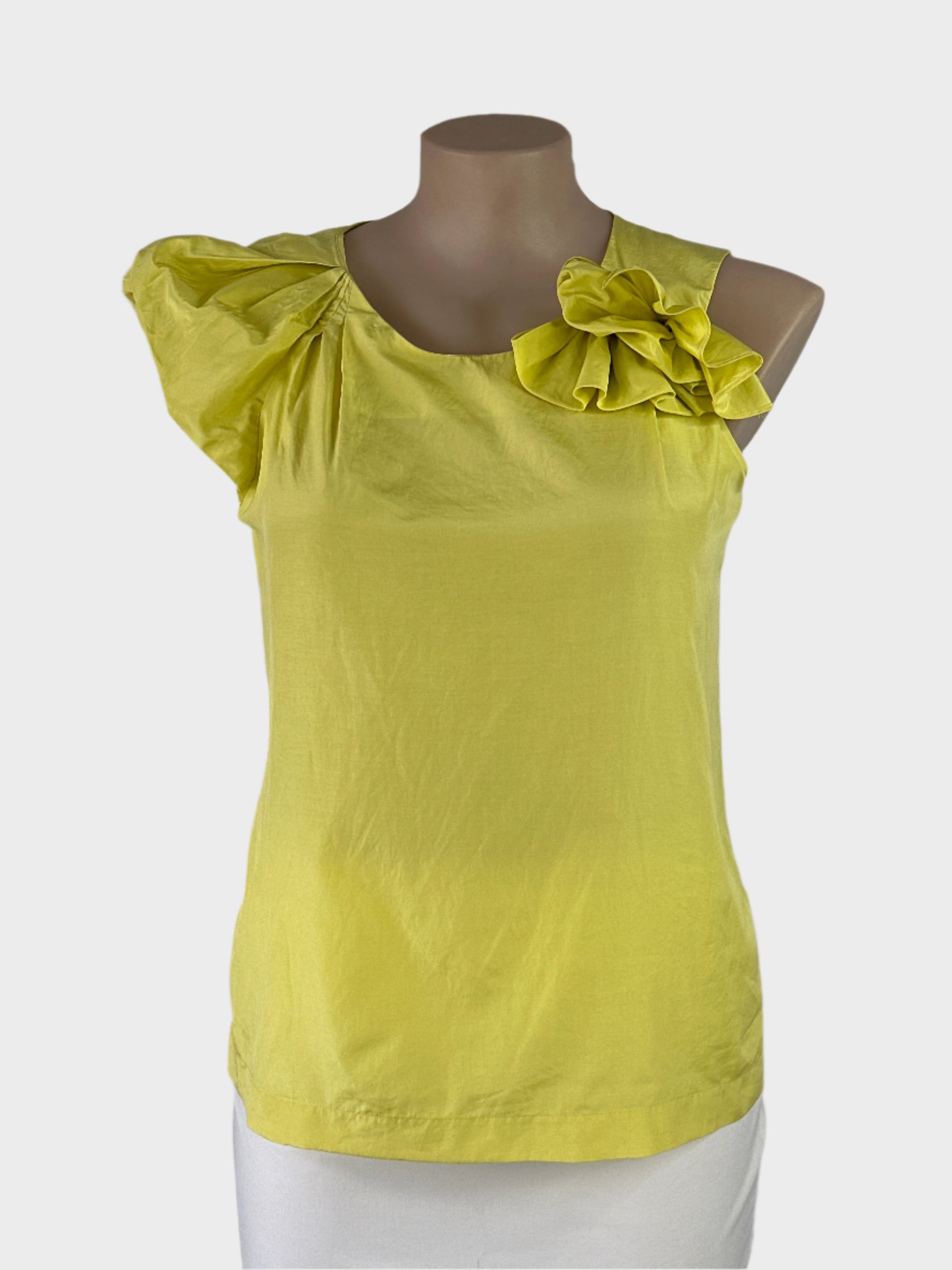 Veronika Maine yellow asymmetric top in silk cotton with polished finish, round neck with rosette and pleated cap sleeve for office wear or smart casual.