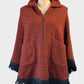 Vintage 60's poncho in black and red boucle wool with fringe trim for smart casual wear.