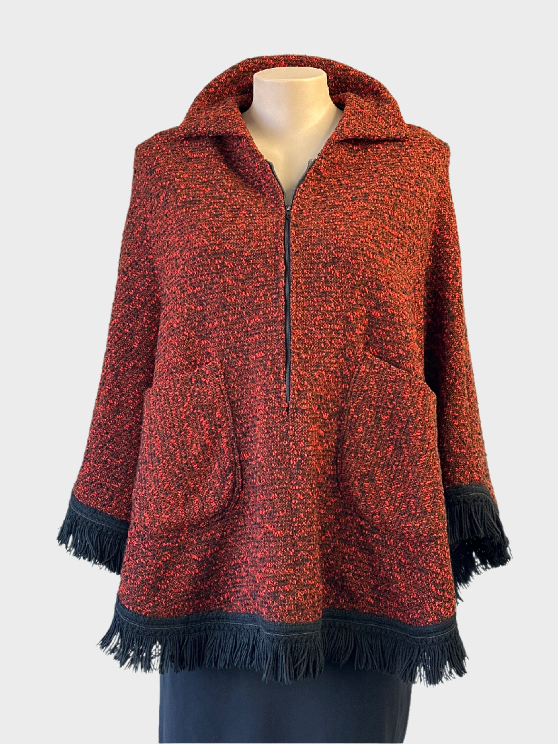 Vintage 60's poncho in black and red boucle wool with fringe trim for smart casual wear.