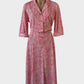 Vintage shirt dress in pink jersey with hatched line print, standard collar and flared skirt for office or smart casual wear.