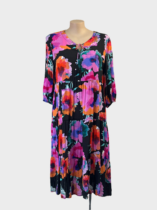 Virtuelle multicoloured smock dress in bright floral print with tassel tie neck for resort or smart casual wear.