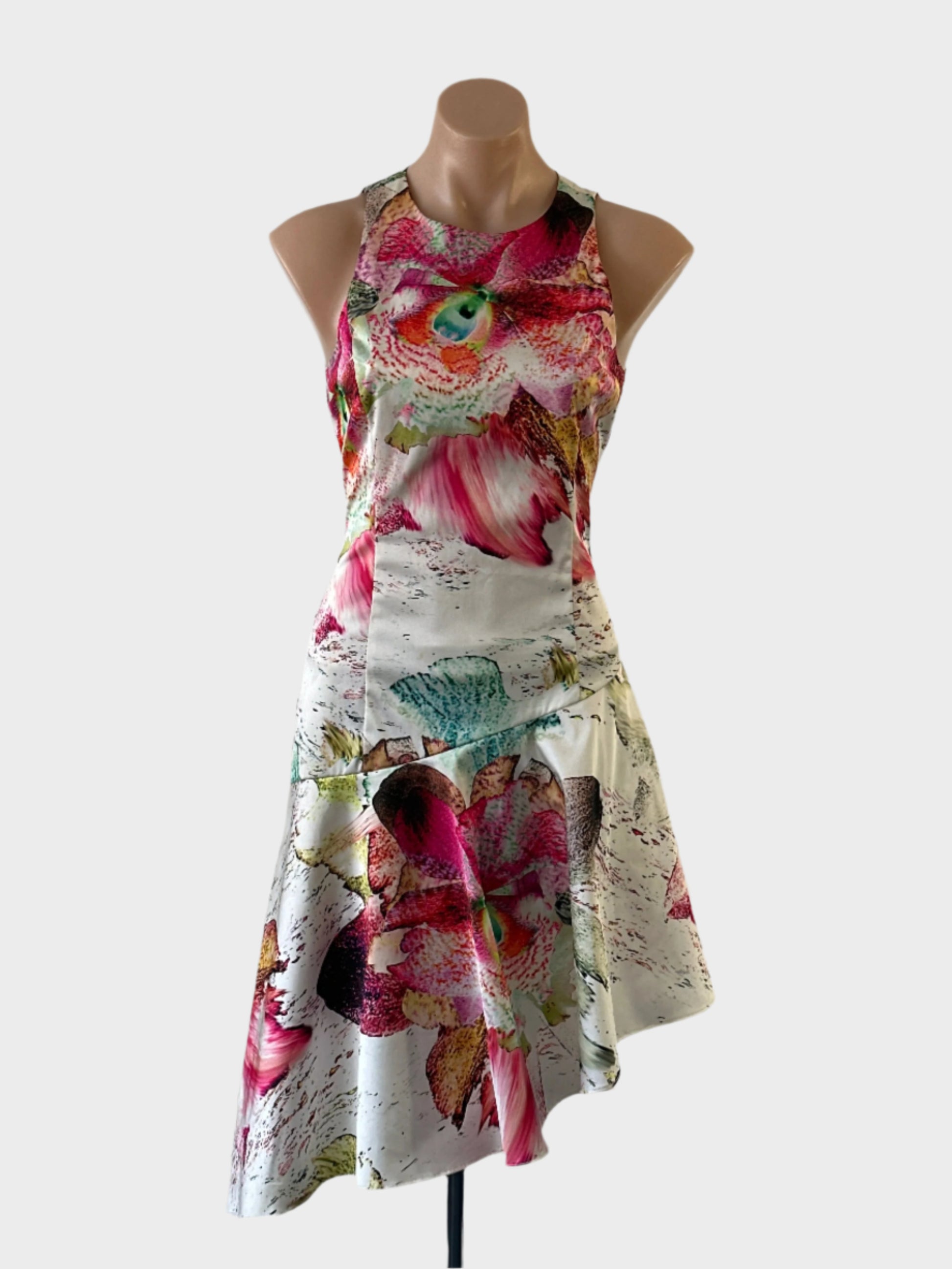 Designer Wayne Cooper asymmetric dress in multicoloured tropical orchid print with drop waist and slanted hem for evening or special events.