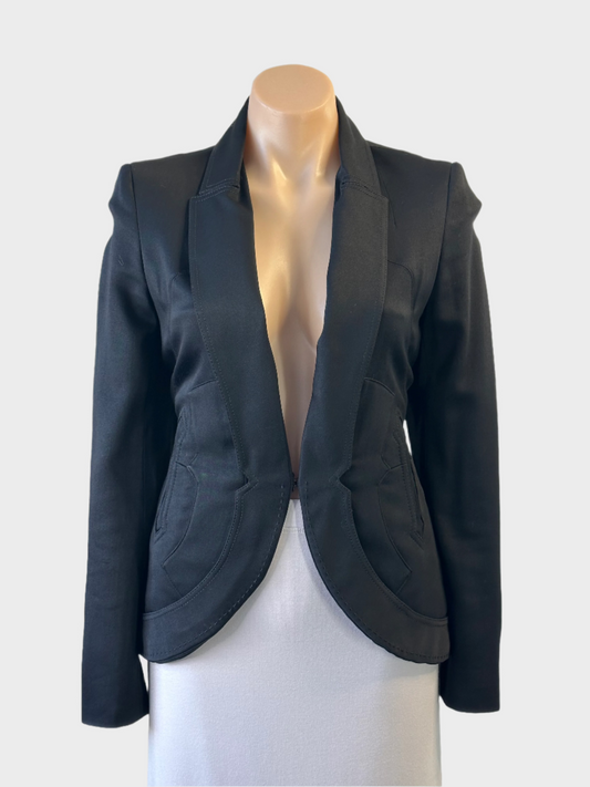 Designer Zac Posen jacket in black with curved hem and topstitching for evening wear.